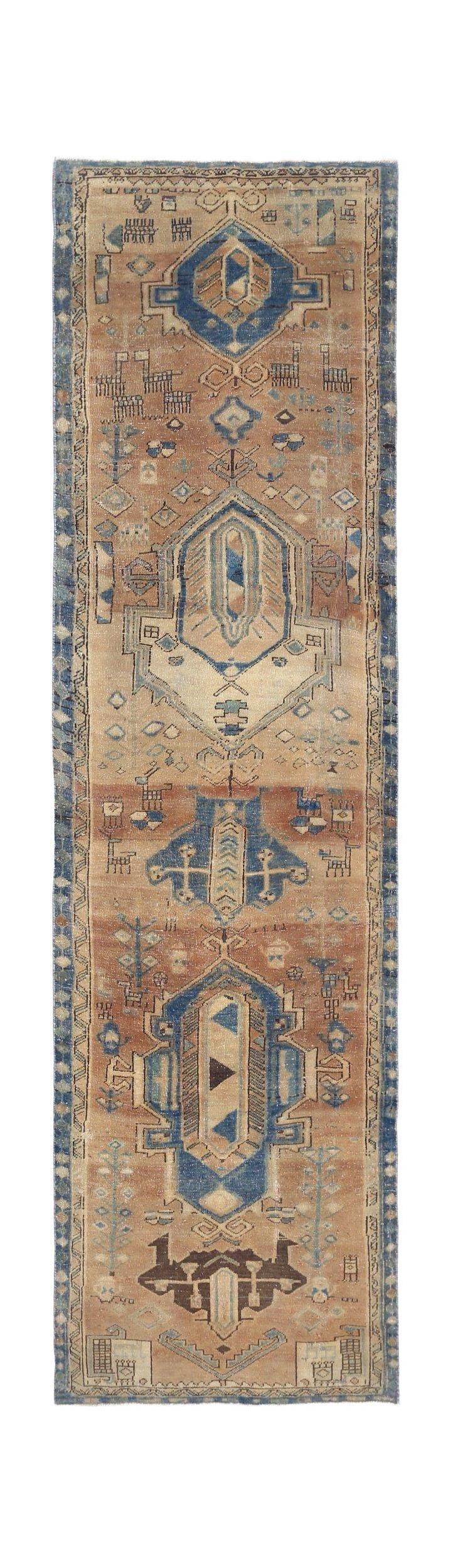A vintage Persian Hamadan runner featuring geometric blue medallions on a tan wool field.