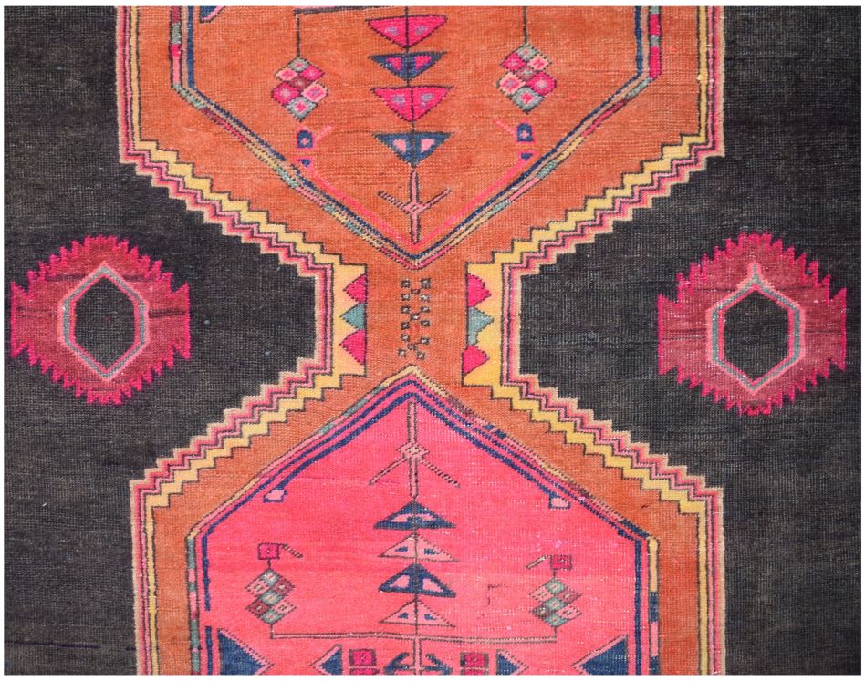 A vintage Persian Hamadan runner featuring geometric patterns in orange, pink, and black wool.