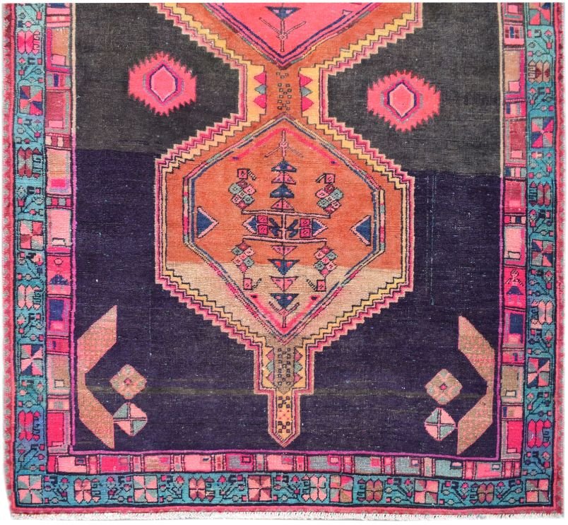 A vintage Persian Hamadan runner featuring a geometric medallion on a dark purple wool field.