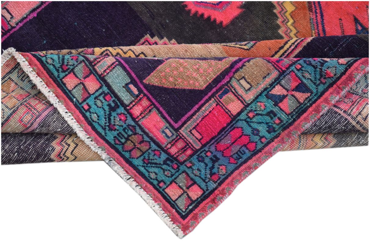A vintage Persian Hamadan runner featuring geometric patterns in vibrant pink, blue, and black.