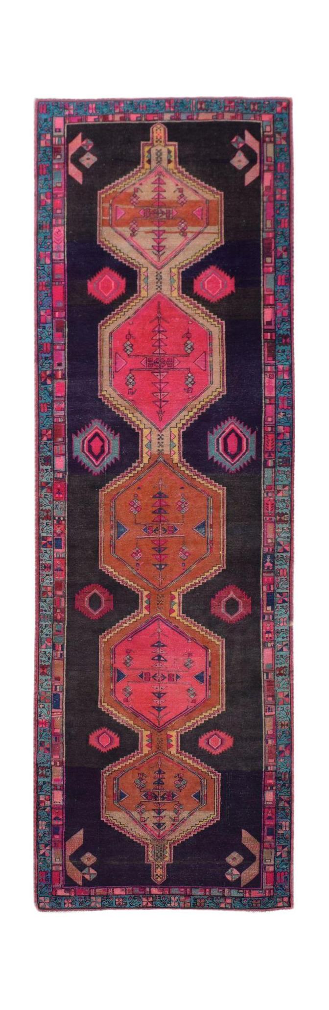 A vintage Persian Hamadan runner featuring geometric medallions in pink and orange on a dark field.