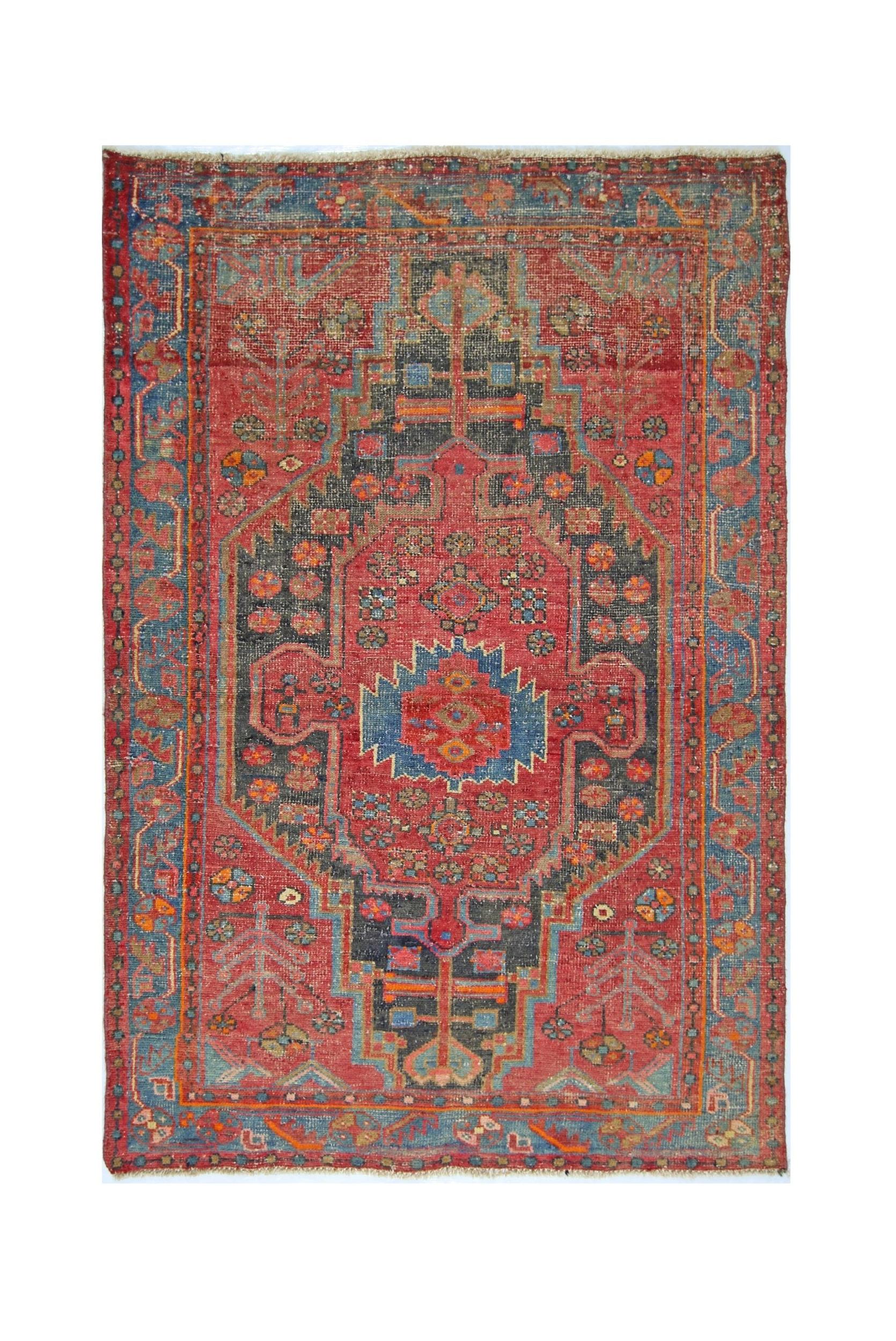A vintage handmade Persian Hamadan rug featuring a central geometric medallion on a red field.