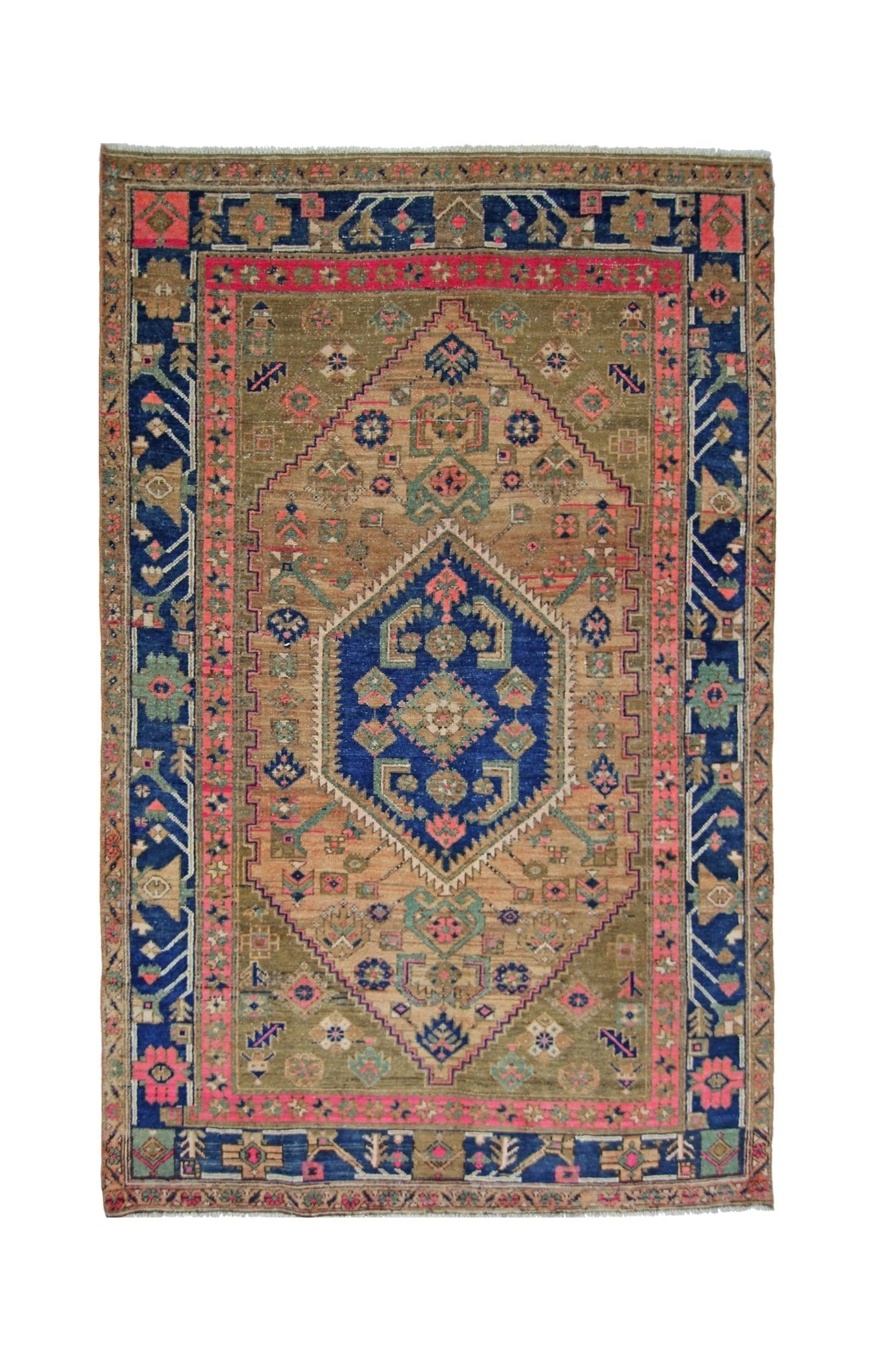 A vintage handmade Persian Hamadan rug featuring a central blue medallion on a tan field.