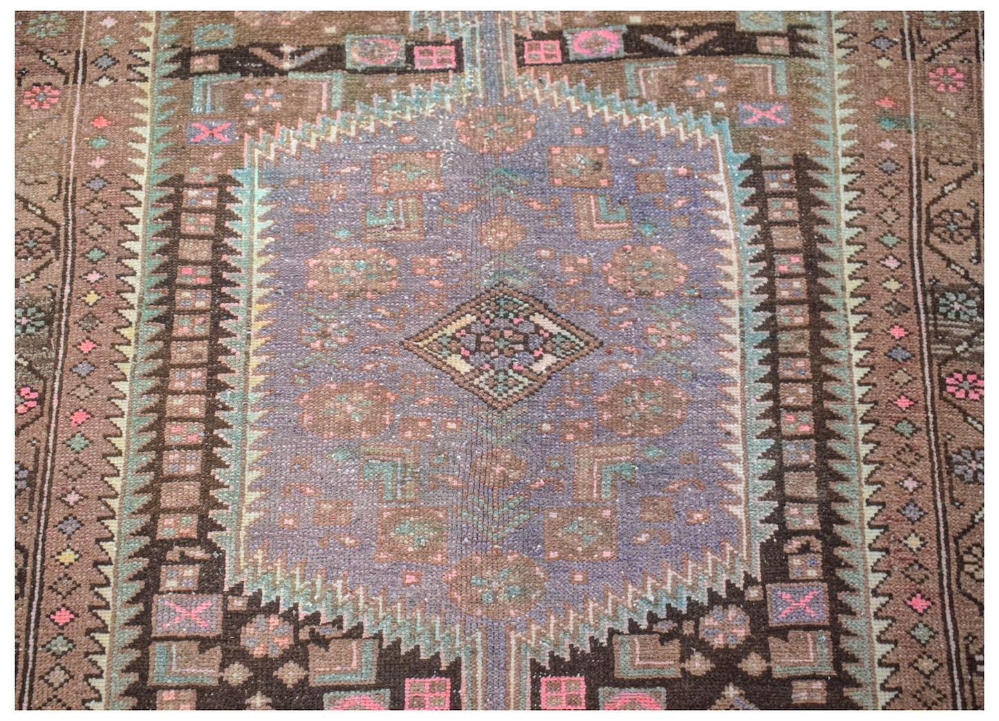 Vintage Persian Hamadan rug featuring a central purple medallion with geometric floral motifs.