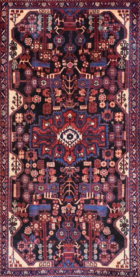 A vintage handwoven Persian Hamadan rug featuring a geometric floral pattern in red and blue.
