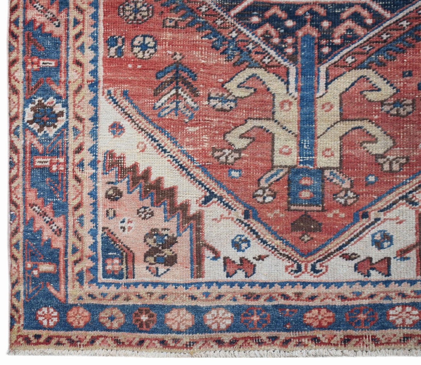 A vintage handwoven Persian Hamadan rug featuring a geometric floral pattern in red and blue.
