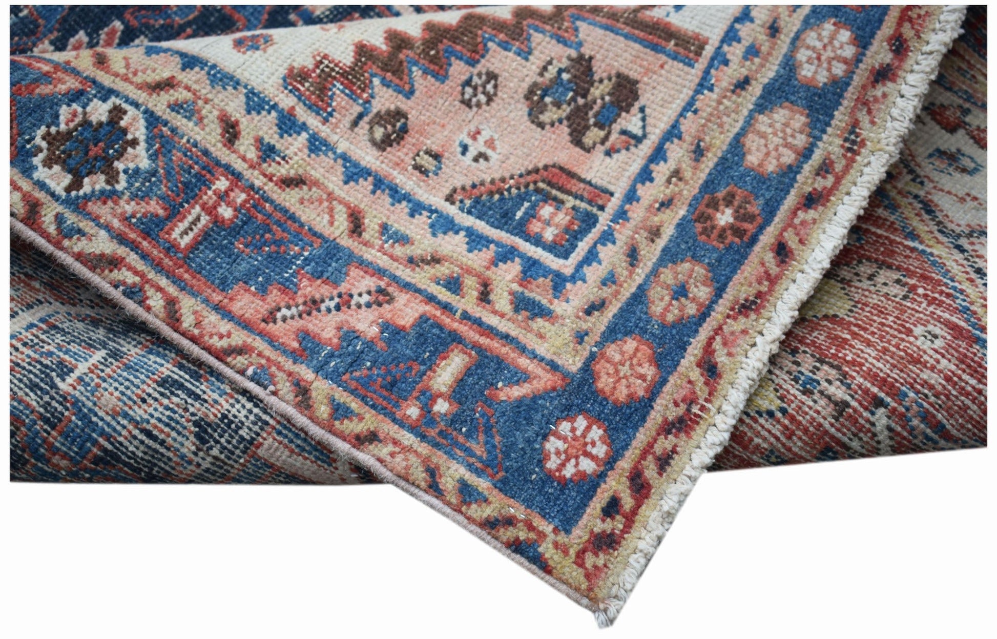 A vintage handwoven Persian Hamadan rug featuring a blue and red geometric floral pattern.