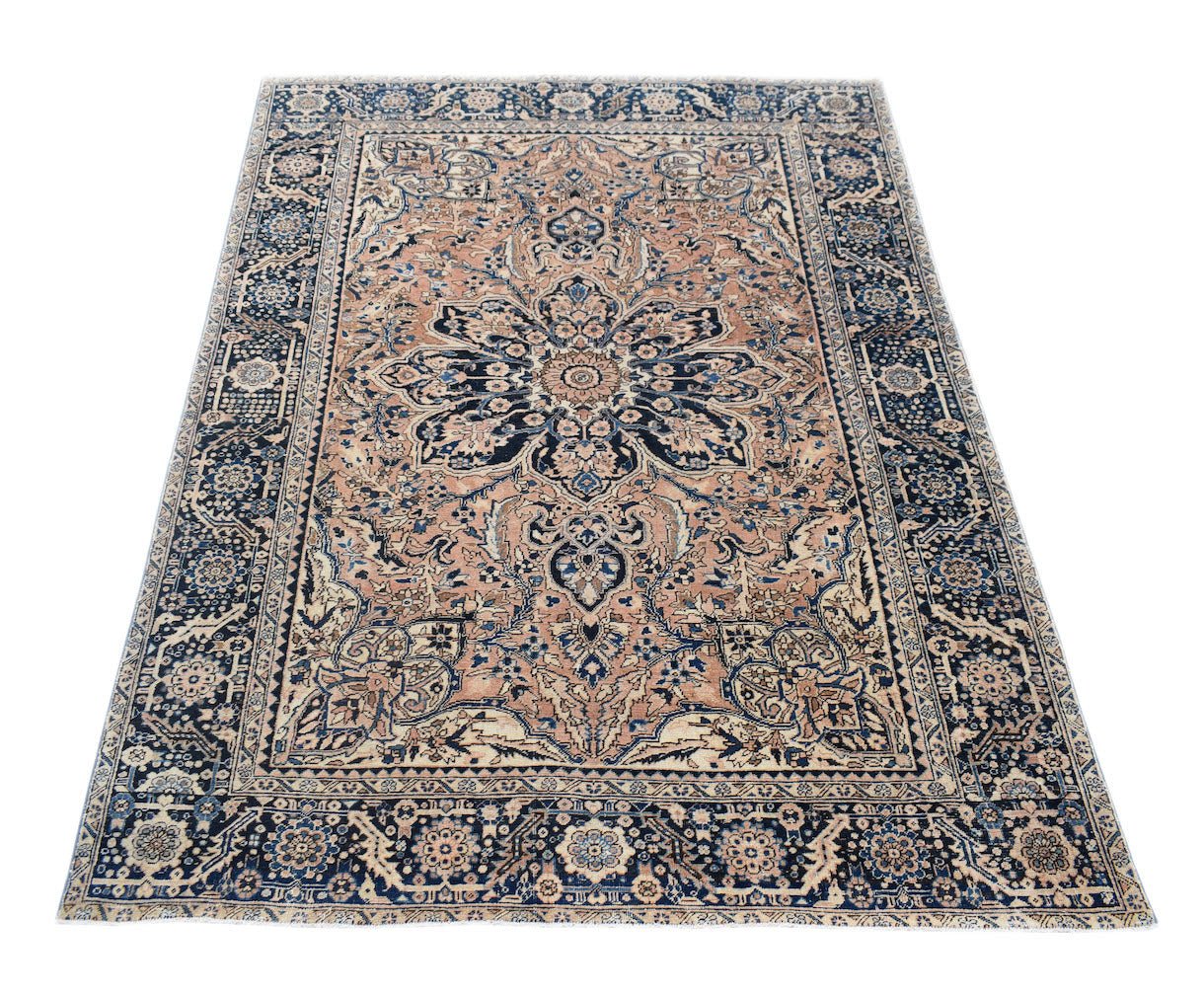 Vintage Persian Heriz rug featuring a central floral medallion on a tan field with blue borders.