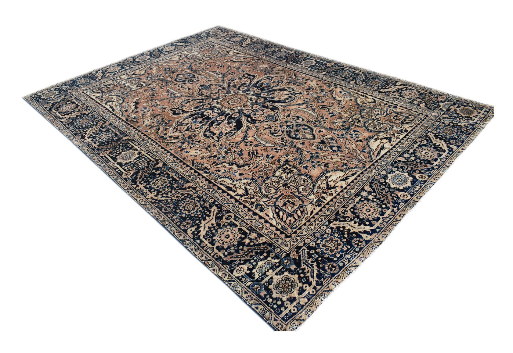 A vintage handwoven Persian Heriz rug featuring a large central medallion in blue and tan tones.