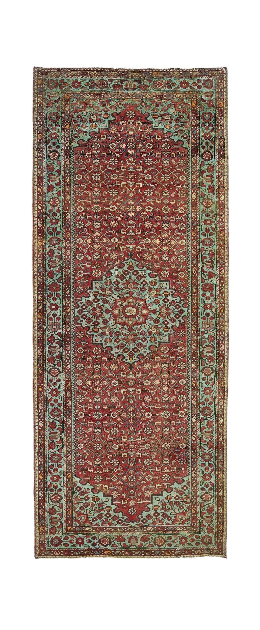 A vintage Persian Hossainabad runner featuring a red field with a central teal medallion.