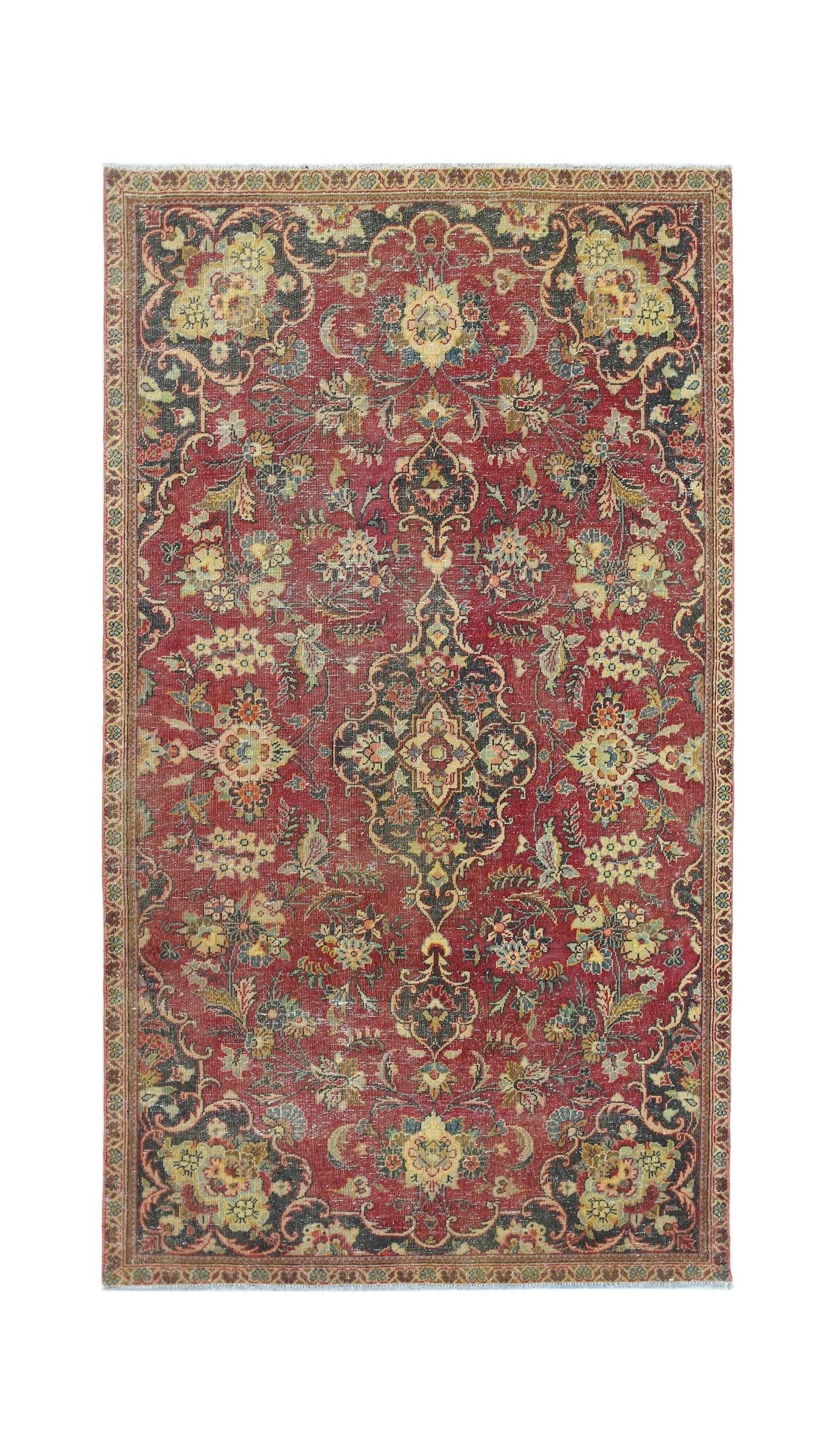 A vintage Persian Kashan rug featuring a floral medallion pattern in red, blue, and cream tones.