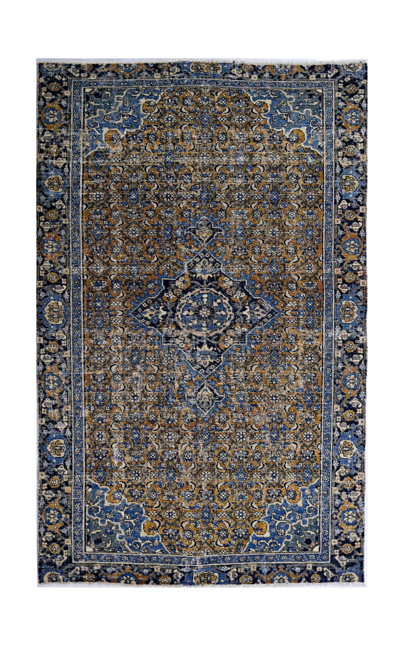 A vintage handmade Persian Hossainabad rug featuring a blue and gold floral medallion pattern.