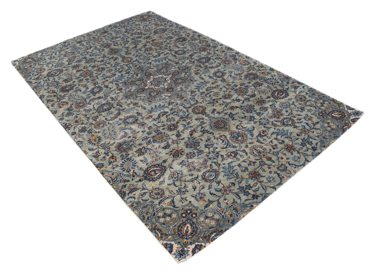 A vintage handwoven Persian Kashan rug featuring intricate floral patterns in shades of blue.