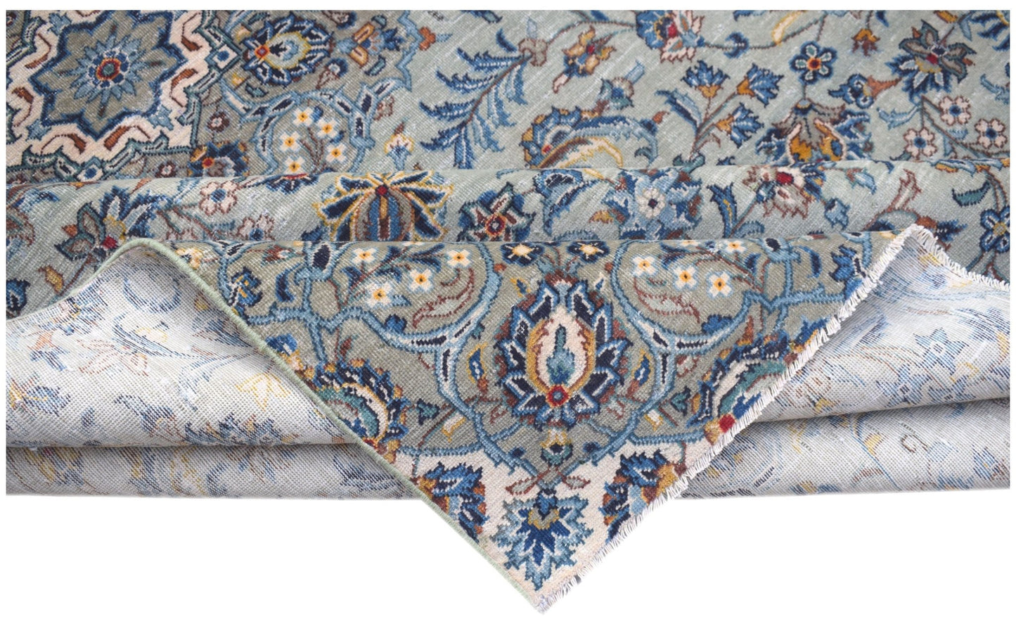 A vintage handwoven Persian Kashan rug featuring intricate blue and cream floral patterns.
