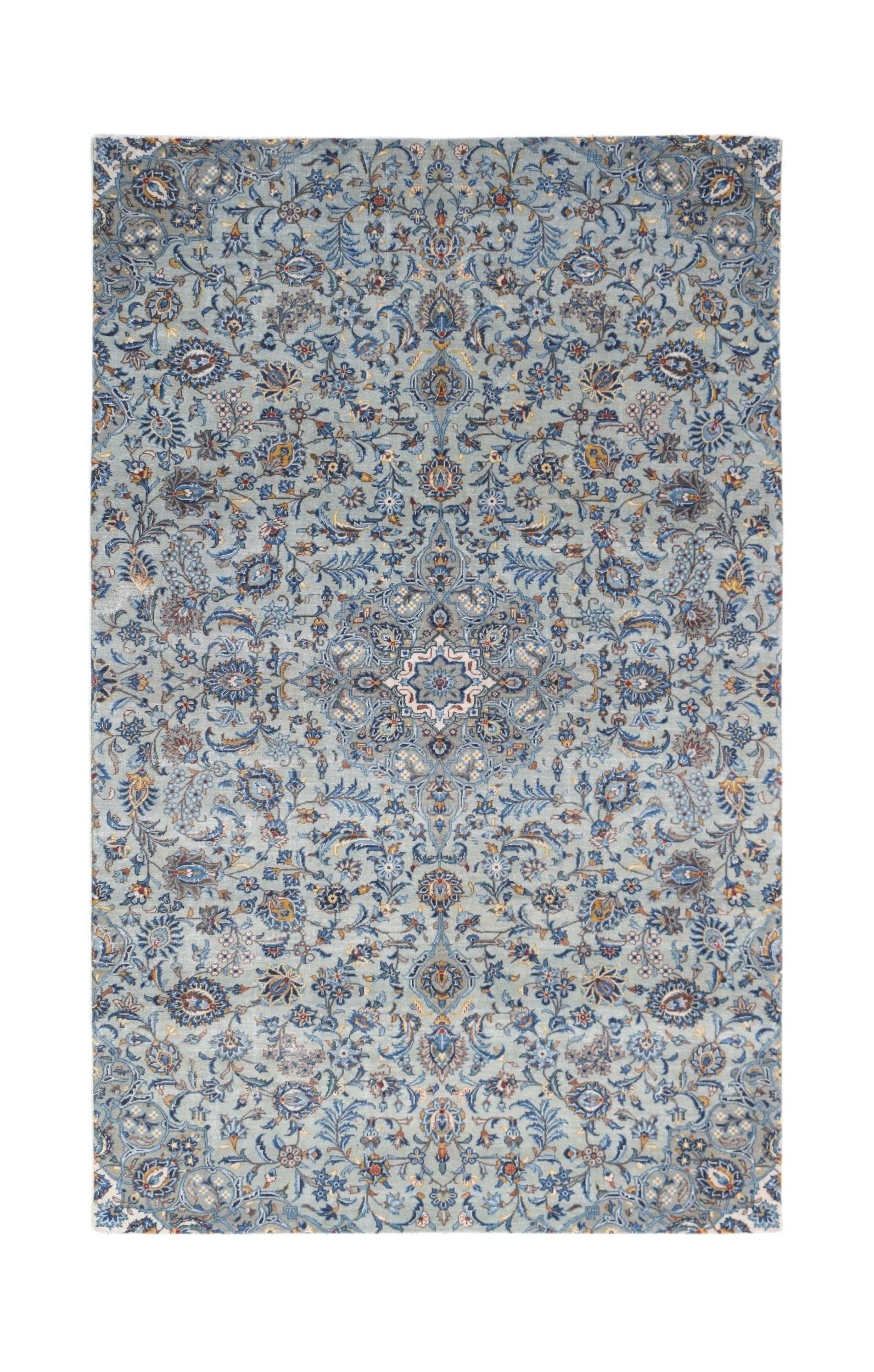 Vintage Persian Kashan rug featuring an intricate floral pattern in shades of blue and cream.