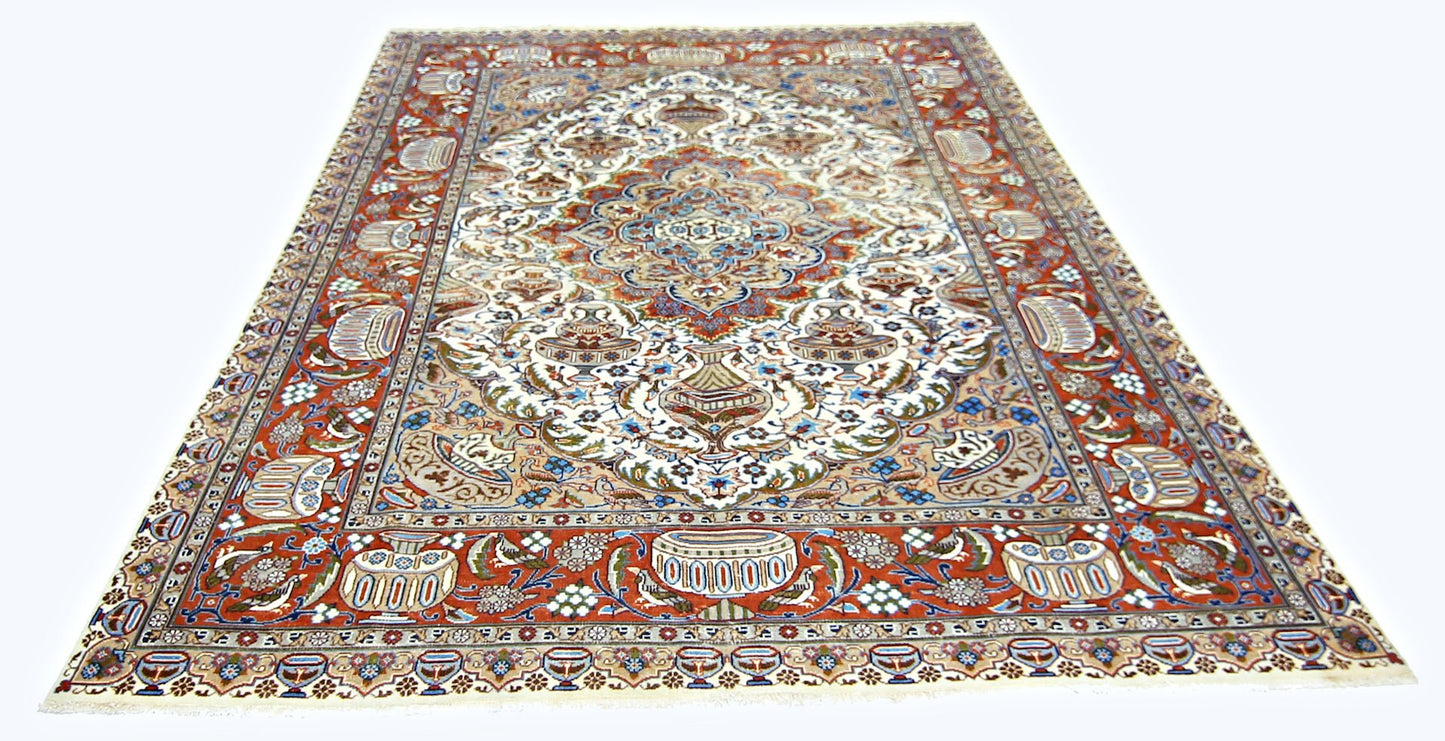 A vintage Persian Kashmar rug featuring an intricate floral and vase pattern in red, blue, and cream.