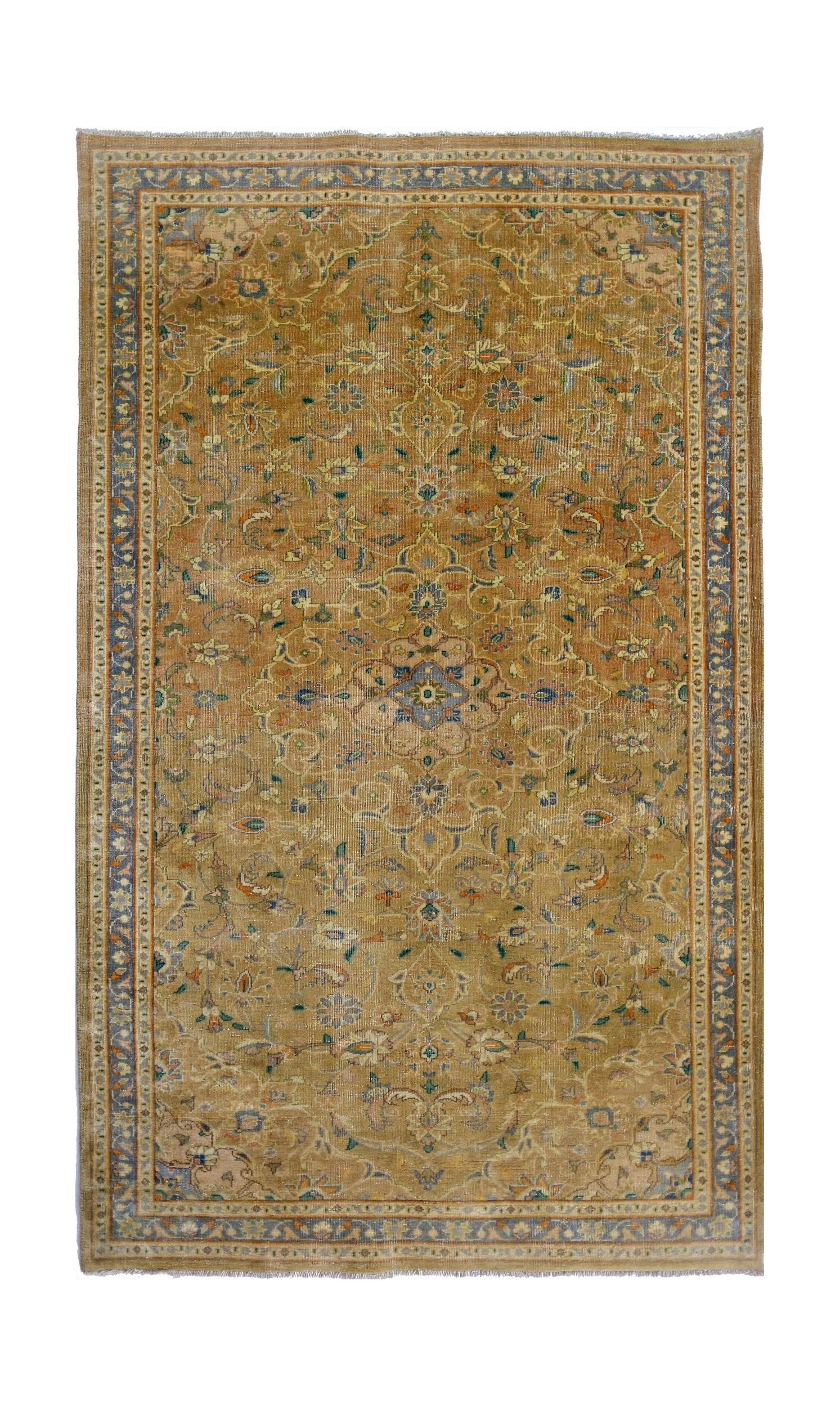 A vintage Pakistani rug featuring an intricate floral medallion design in shades of gold and blue.