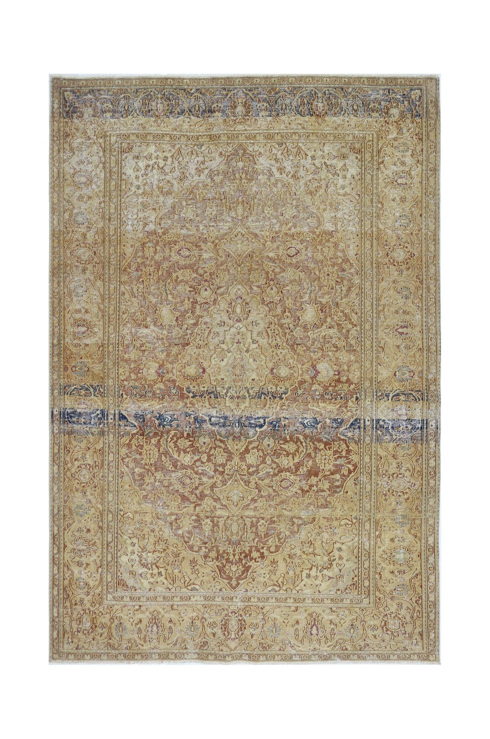 A vintage Persian Kerman rug featuring a central medallion and intricate floral patterns in gold.