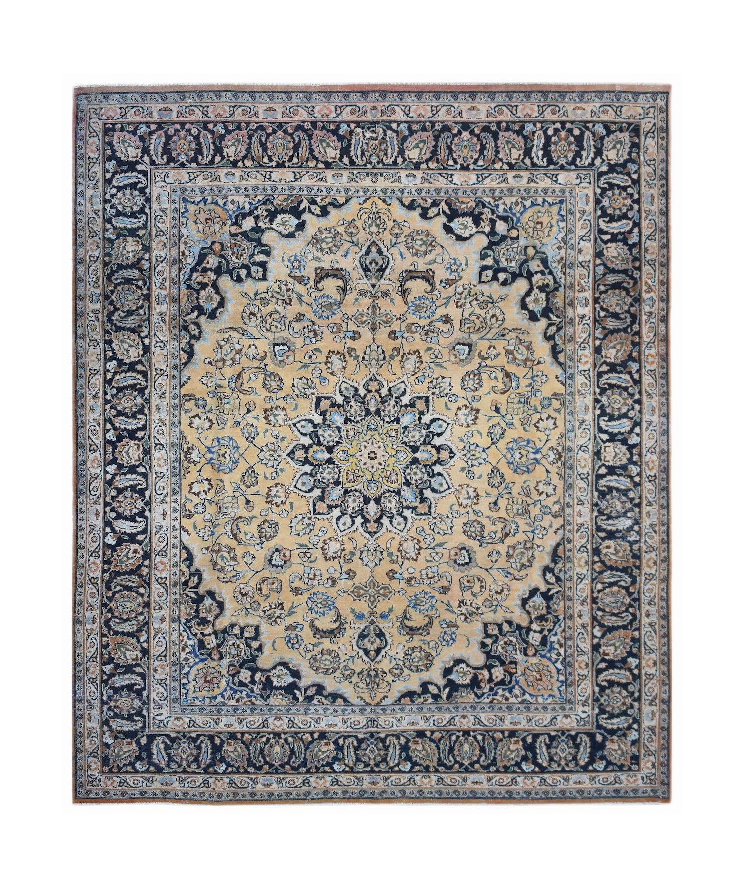 A vintage Persian Kerman rug featuring a central floral medallion on a beige field with dark borders.