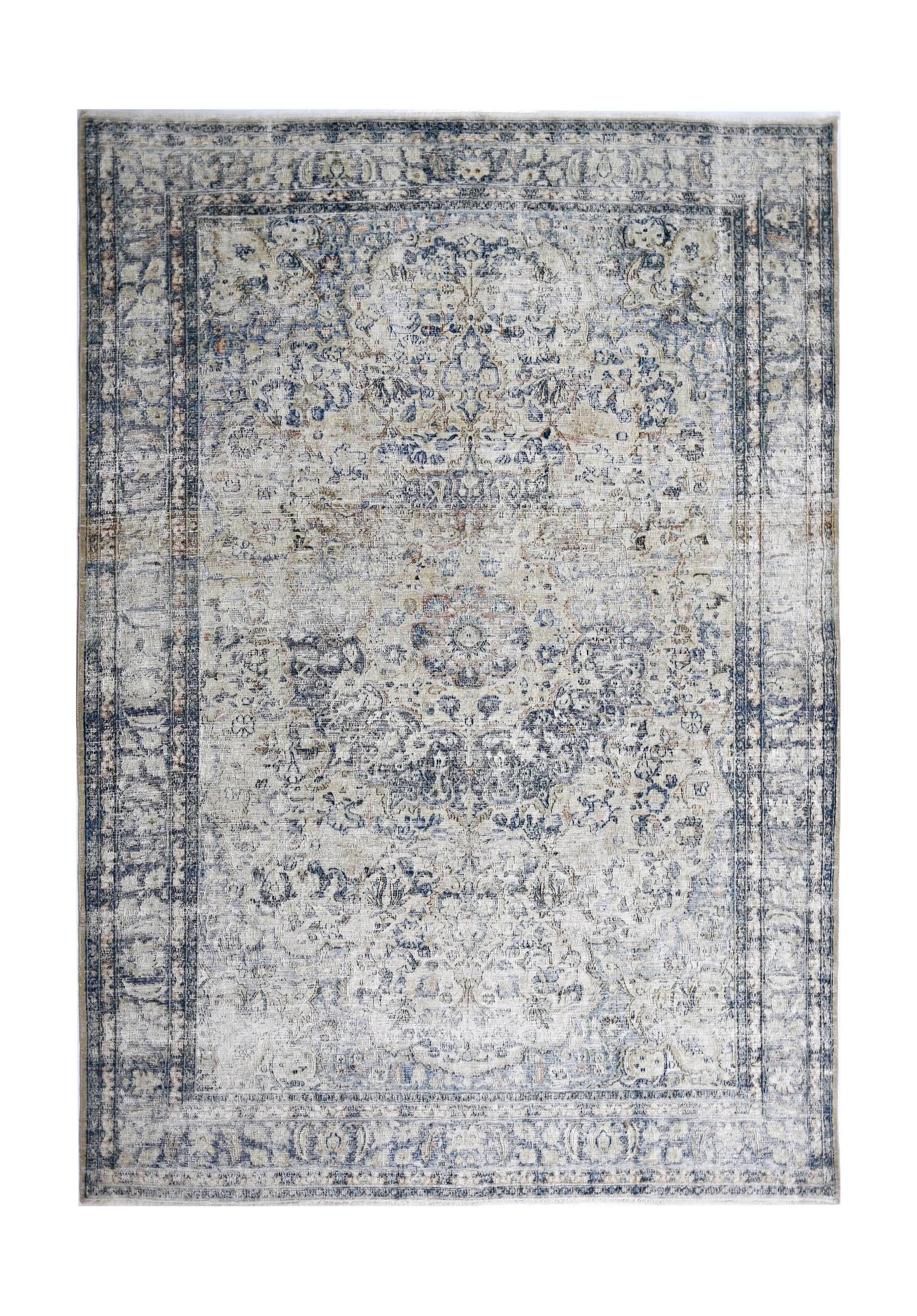 A vintage Persian Kerman rug featuring a central medallion and intricate floral patterns in blue.