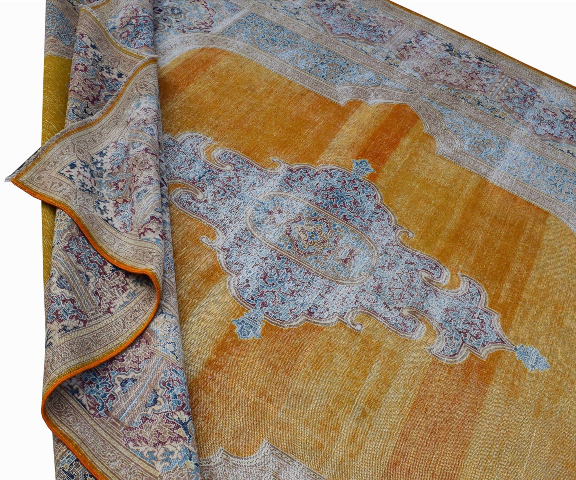 A vintage Persian Kerman rug featuring a central medallion and floral motifs in gold and blue.