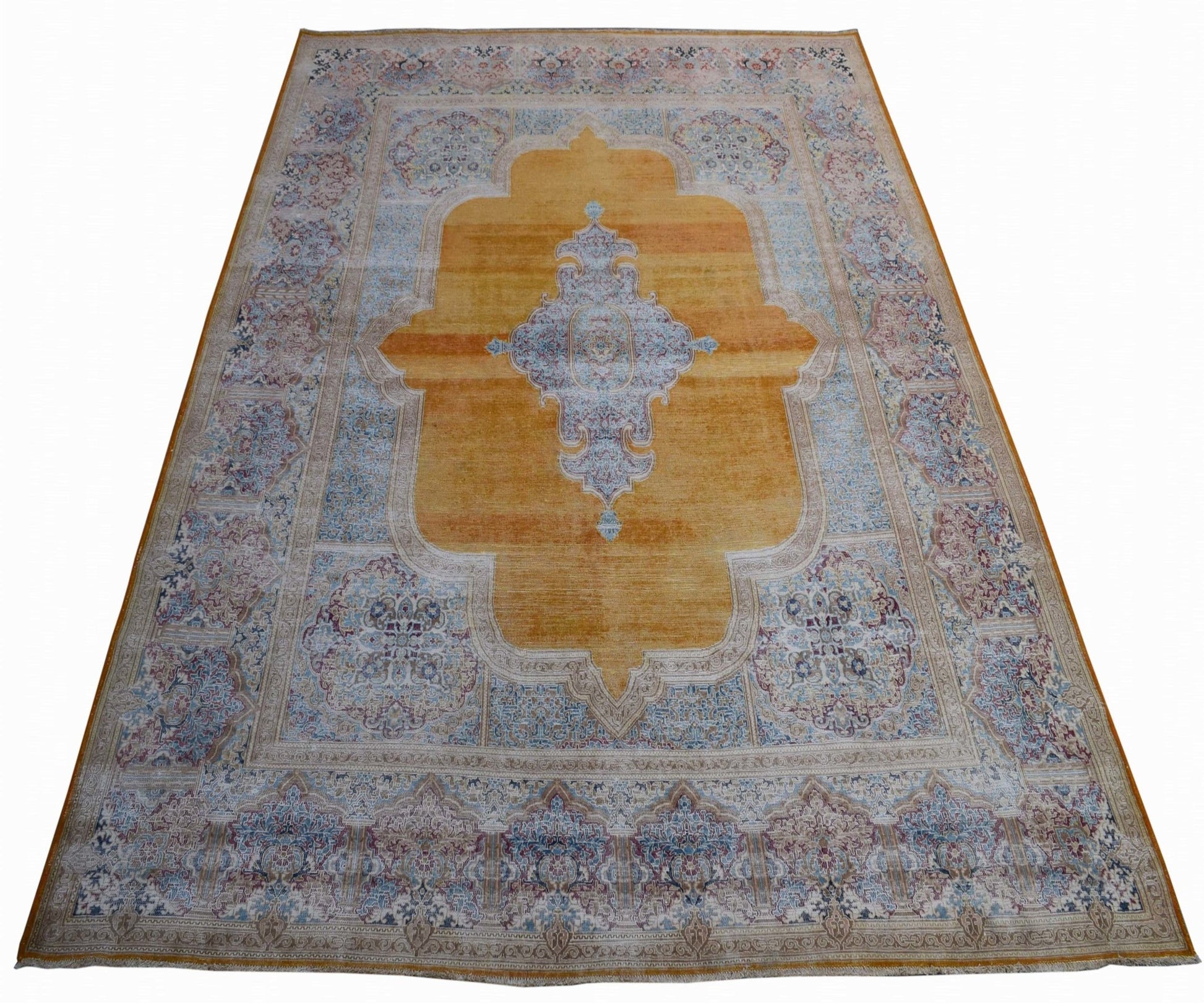 A vintage Persian Kerman rug featuring a central medallion on a golden field with floral borders.