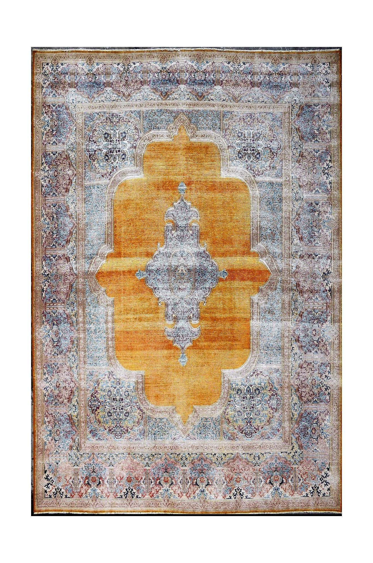 A vintage Persian Kerman rug featuring a central medallion on a golden field with floral borders.