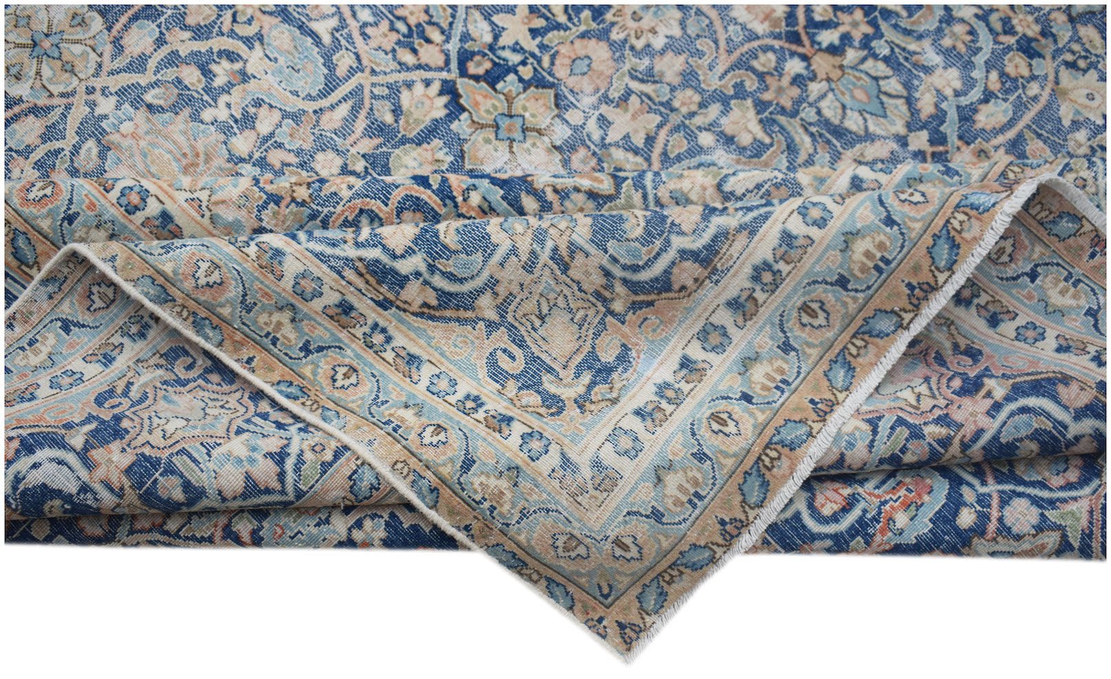 A vintage Persian Kerman rug featuring an intricate blue and beige floral medallion pattern.