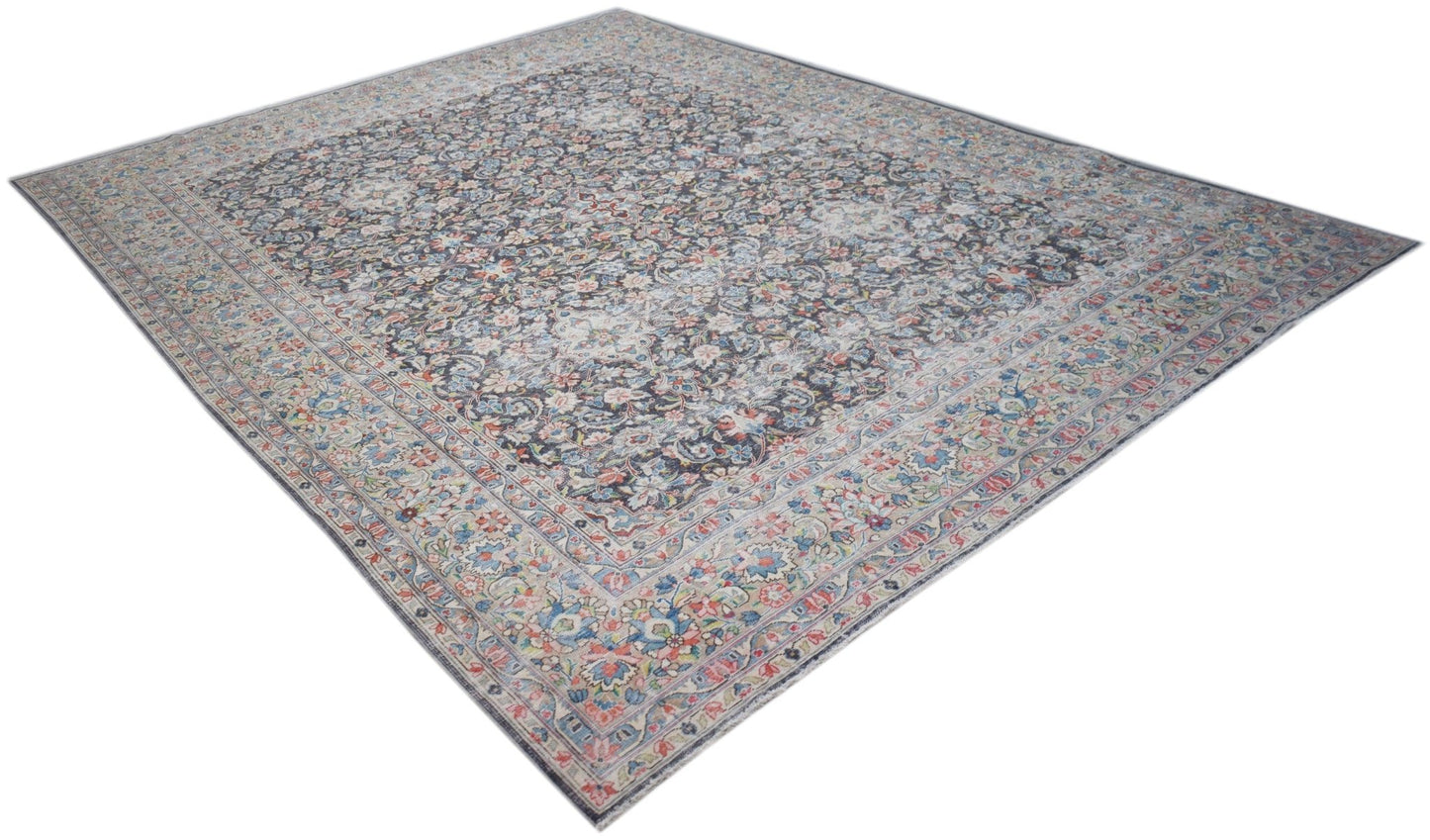 A vintage Persian Kerman rug featuring an intricate floral medallion design in muted tones.