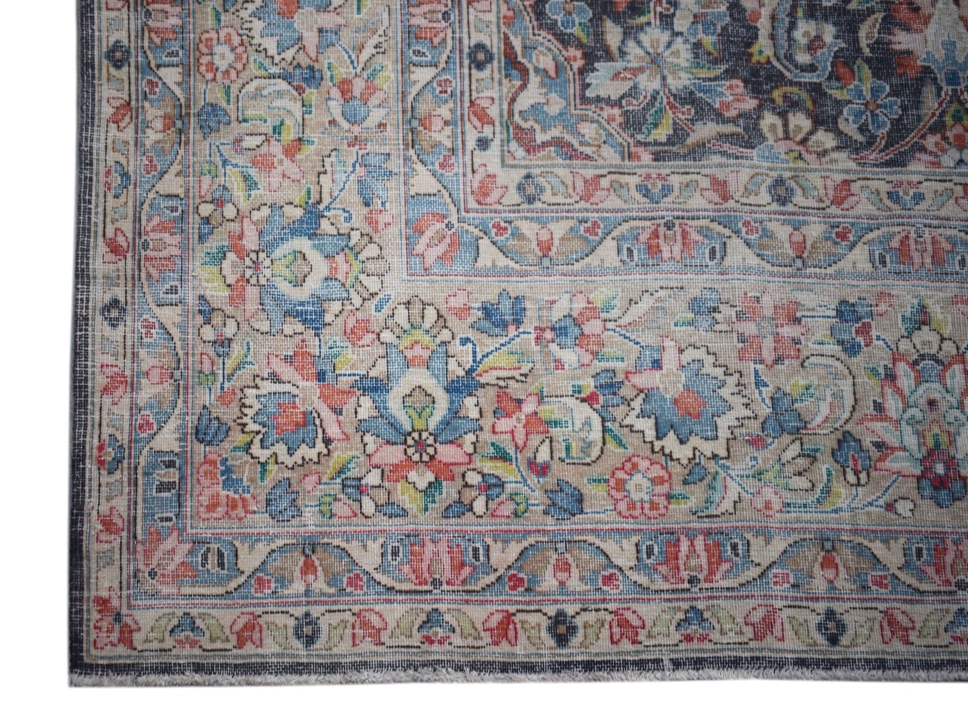 A vintage Persian Kerman rug featuring an intricate floral pattern in soft, curvilinear designs.