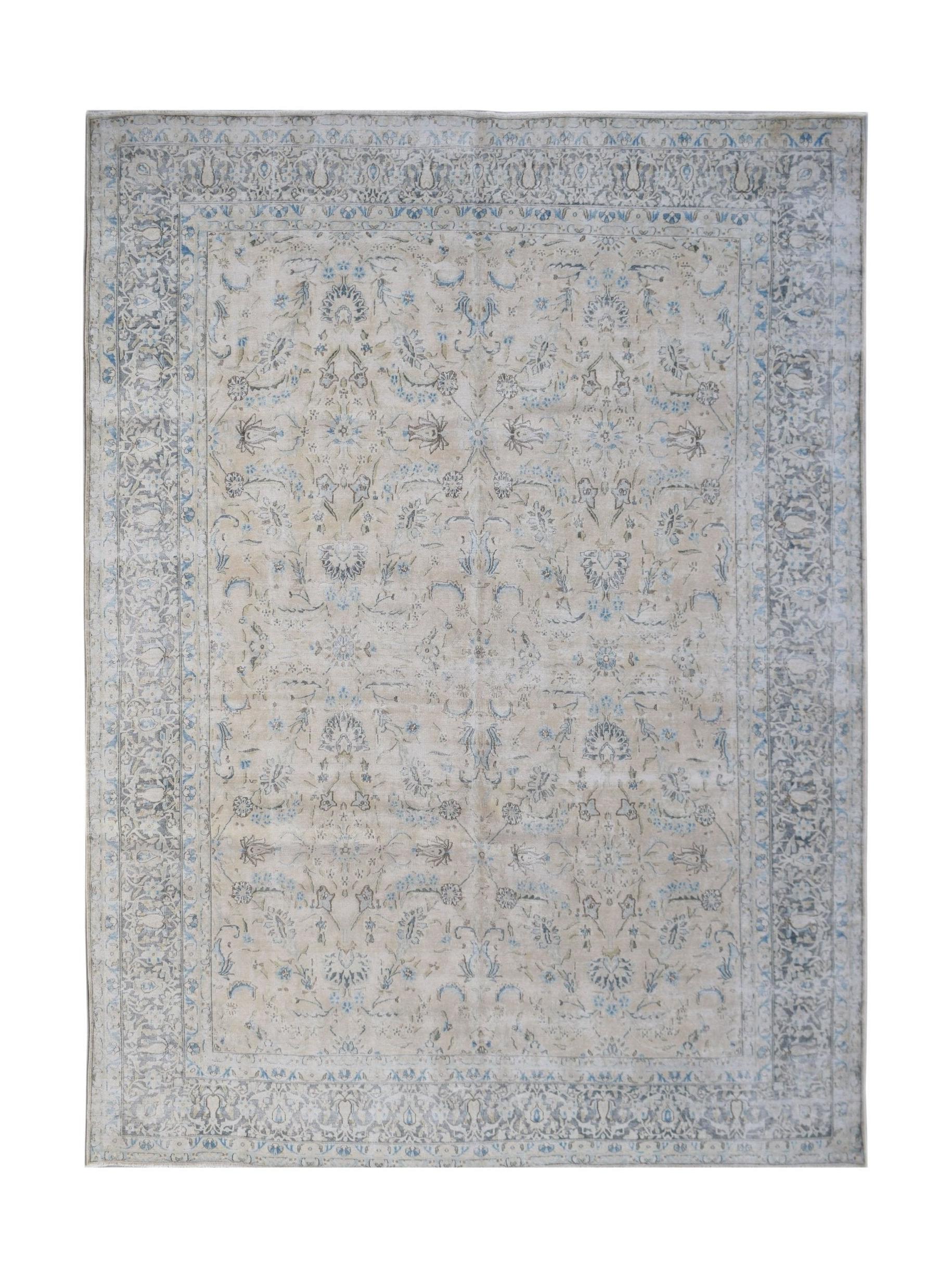 A vintage Persian Kerman rug featuring a soft beige field with intricate blue floral patterns.