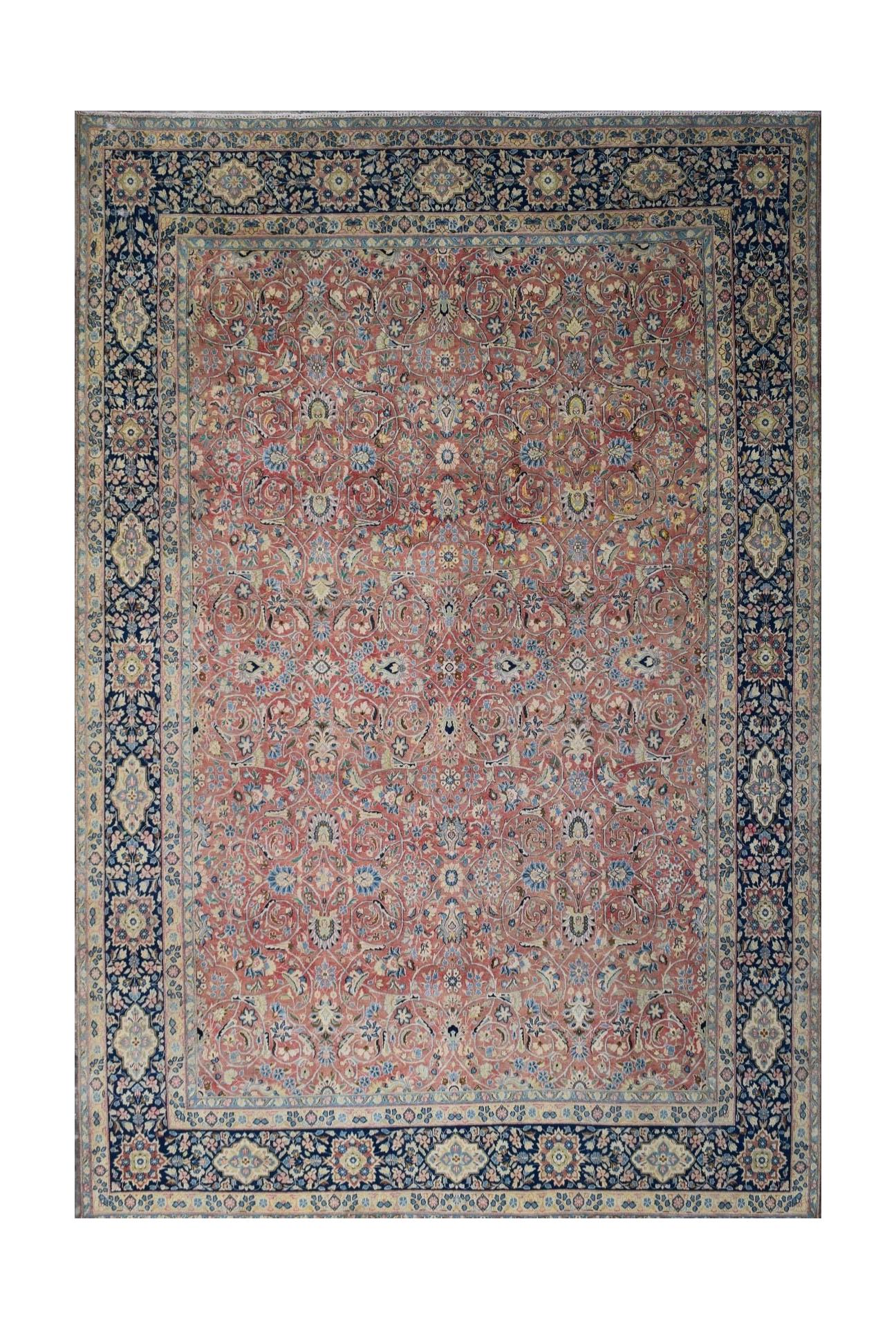 A vintage Persian Kerman rug featuring an intricate floral pattern in soft red and deep blue tones.