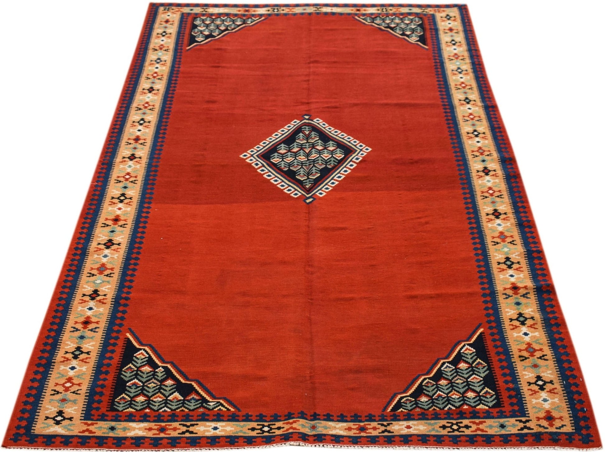 A rectangular vintage Persian kilim featuring a red field with a central diamond and corner motifs.