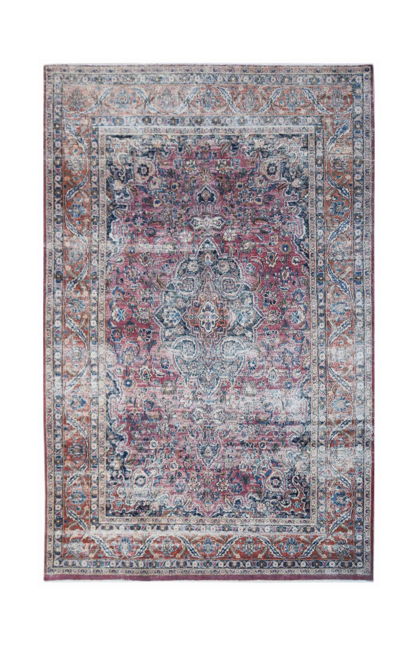 A vintage handwoven Persian Mashhad rug featuring intricate floral patterns in red and blue tones.