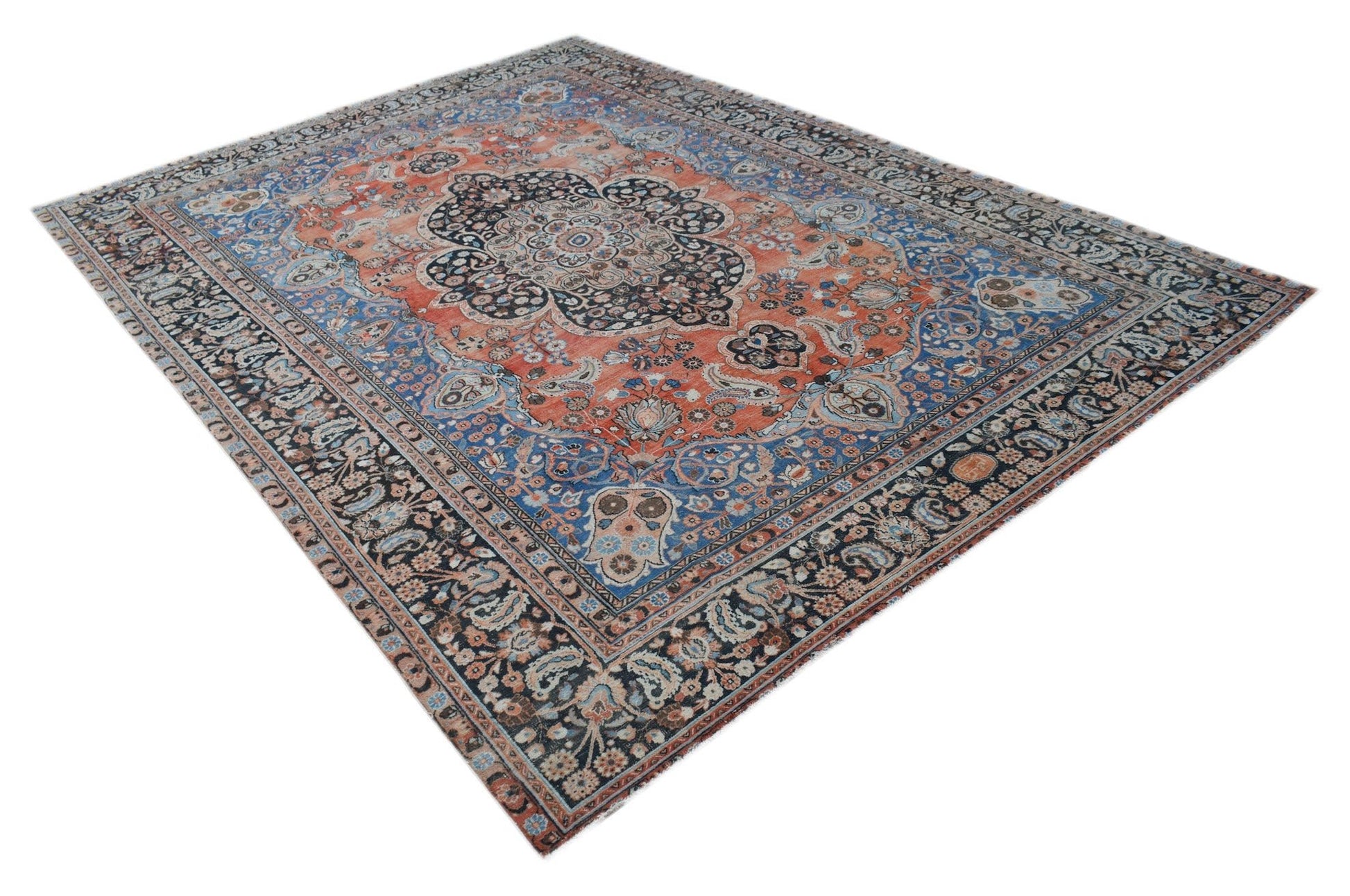 A vintage Persian Moud rug featuring a central medallion on a rust and blue floral field.