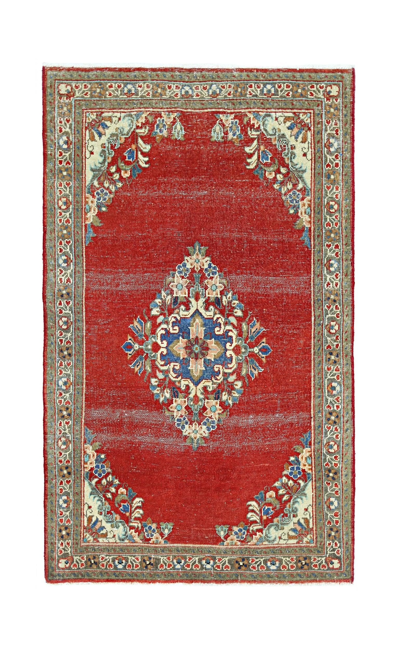 A vintage Persian Tabriz rug featuring a central floral medallion on a red field with ornate borders.