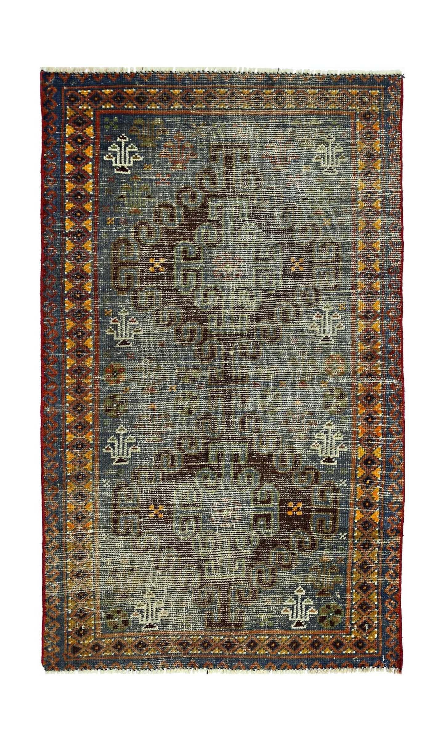 A vintage handmade Persian rug featuring a central geometric motif on a blue field.