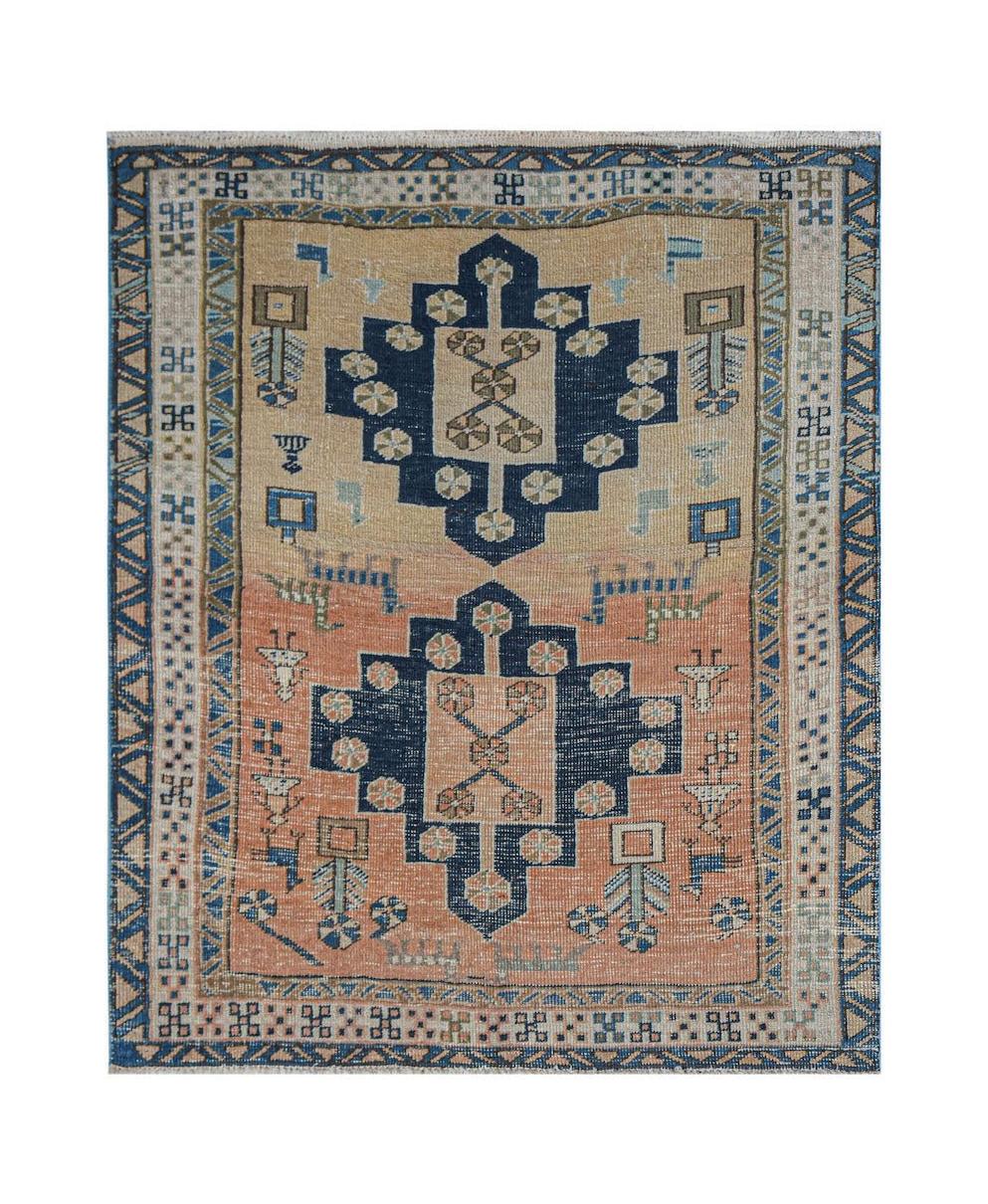 Vintage Persian rug with geometric patterns in blue and peach.