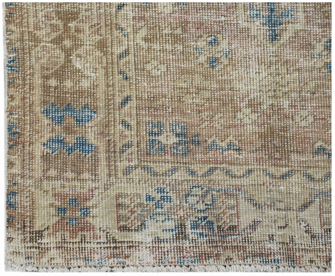 A vintage Persian Hamadan rug featuring a faded geometric pattern in blue, brown, and cream tones.