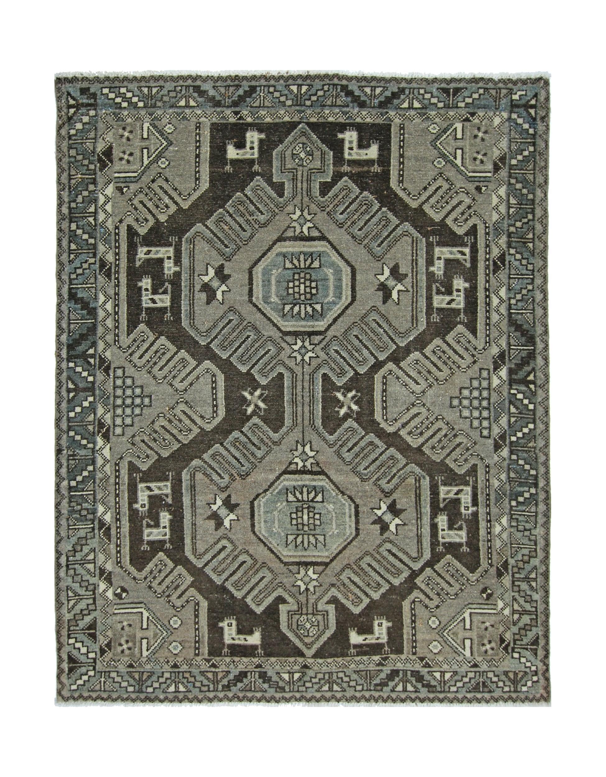 A handmade vintage Persian rug featuring a geometric pattern in shades of grey and brown.
