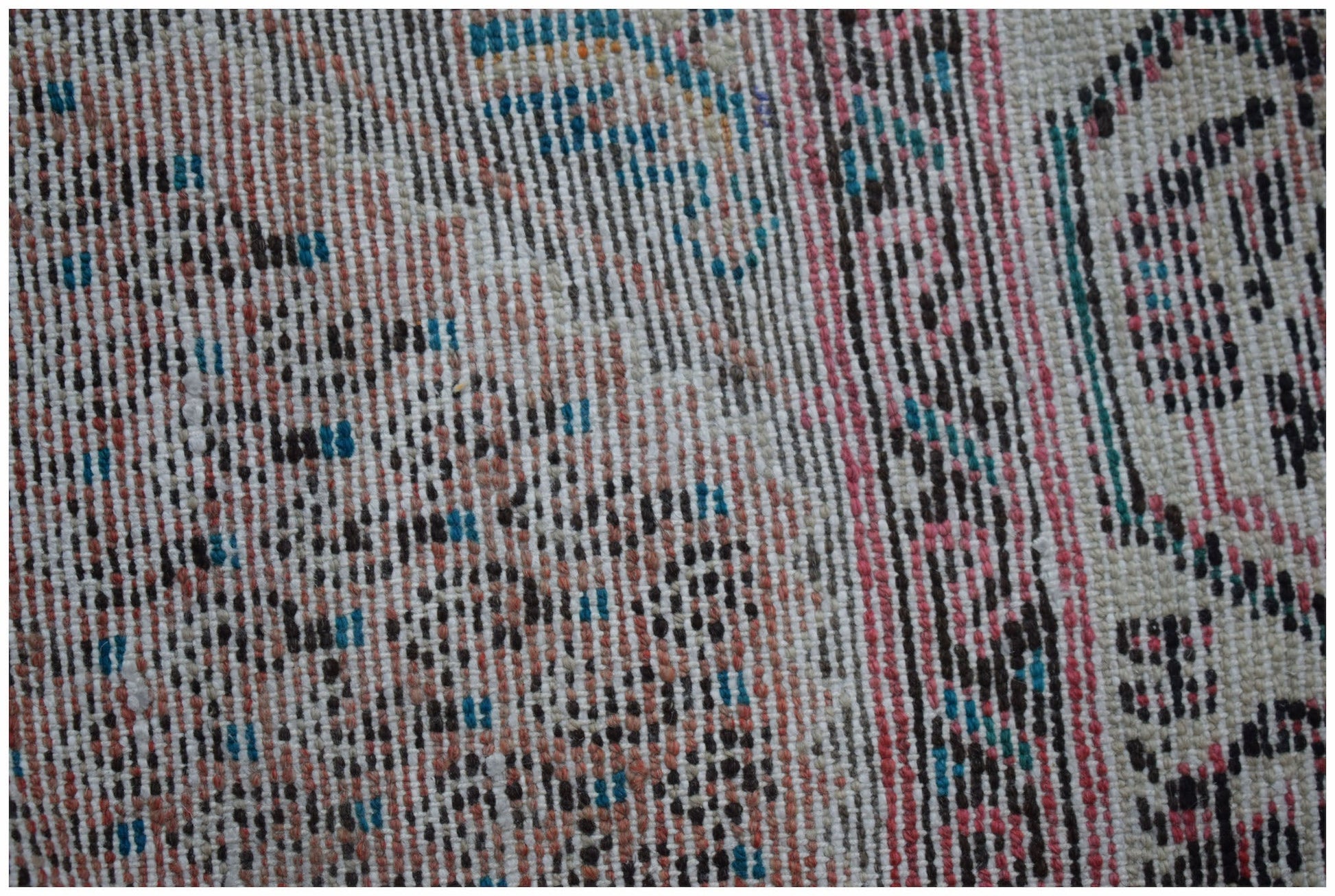 A close-up view of a handwoven vintage Persian rug featuring a textured pattern of wool fibers.