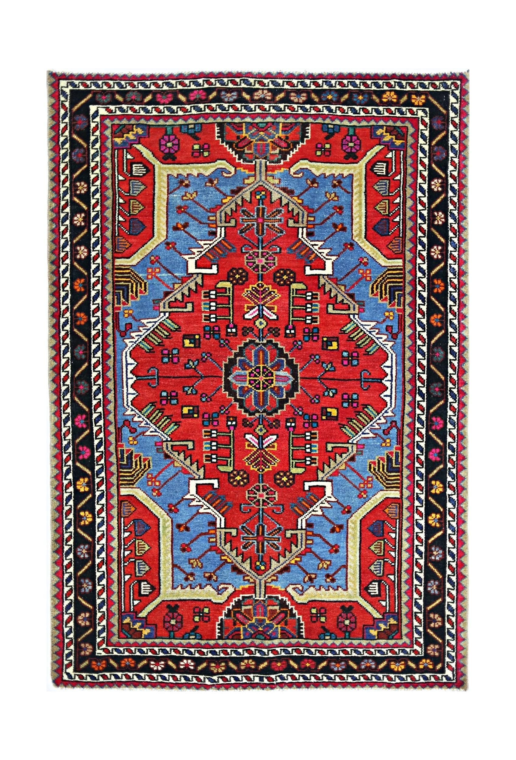 A vintage Persian Hamadan rug featuring a geometric red and blue medallion pattern.