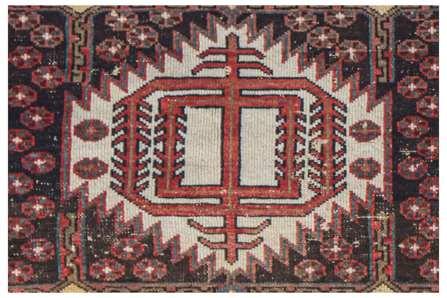 Vintage Persian rug with a central geometric medallion and floral motifs.