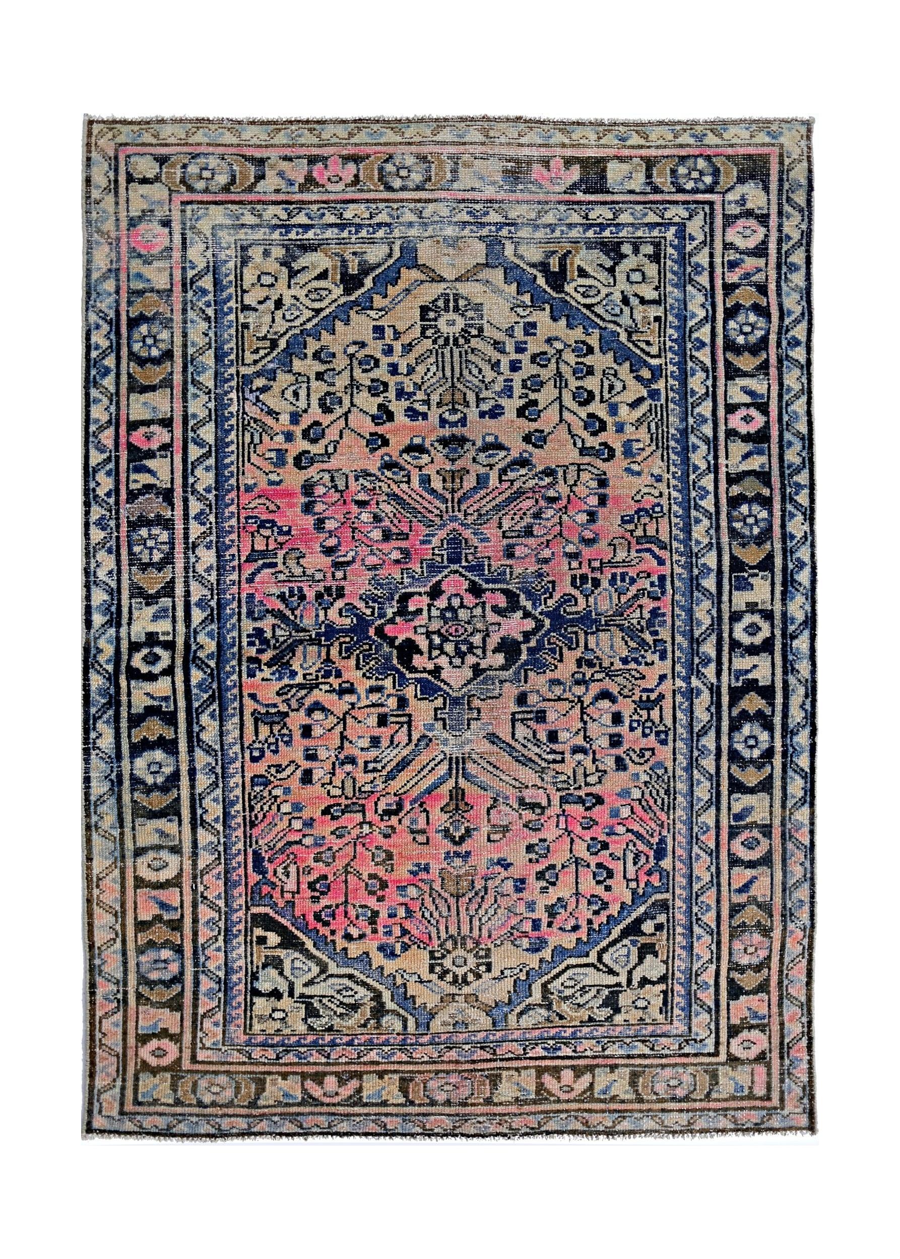 A vintage Persian rug featuring a central medallion with intricate floral patterns in pink and blue.