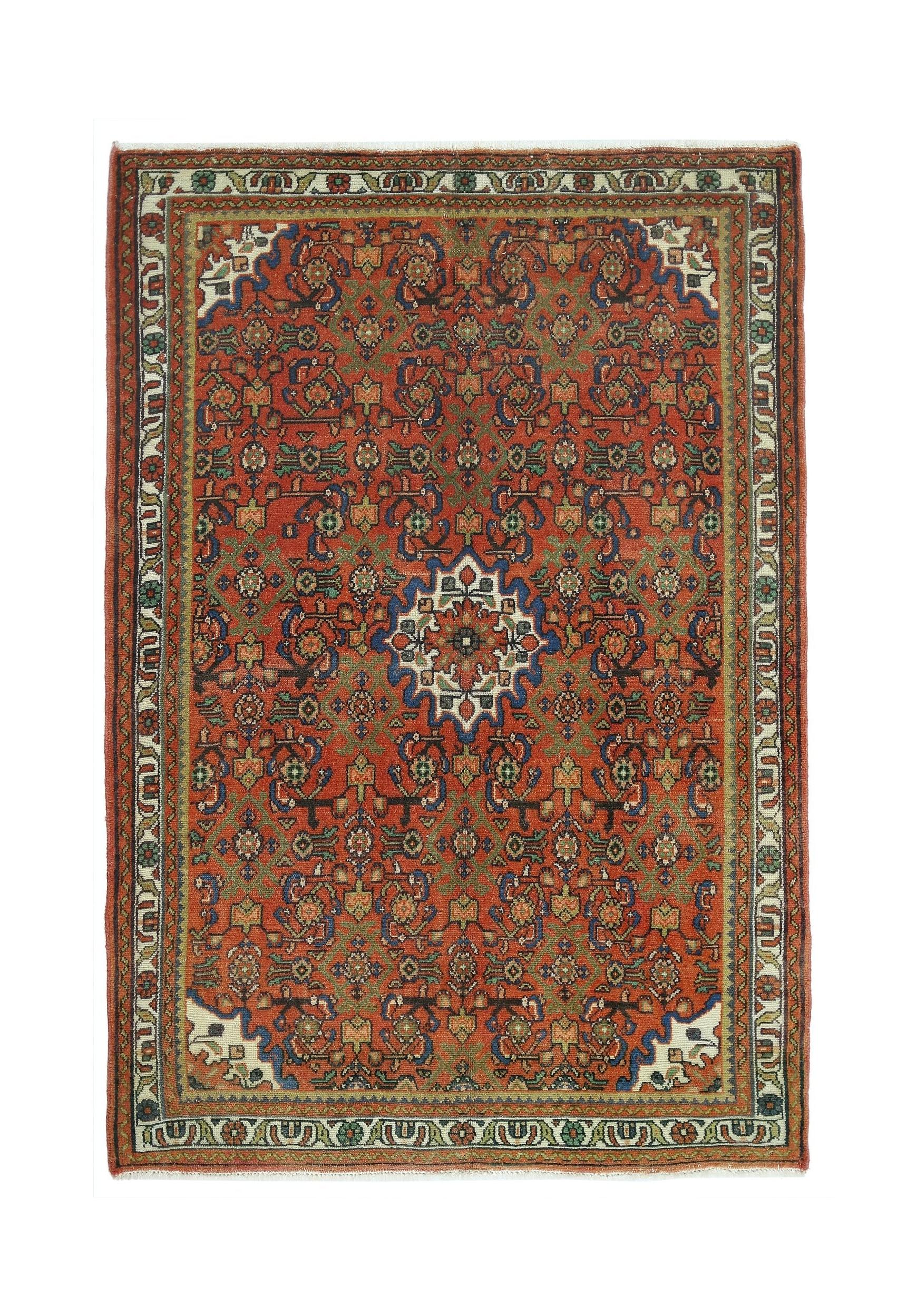 A rectangular vintage Persian rug featuring a red field with intricate blue and green floral motifs.