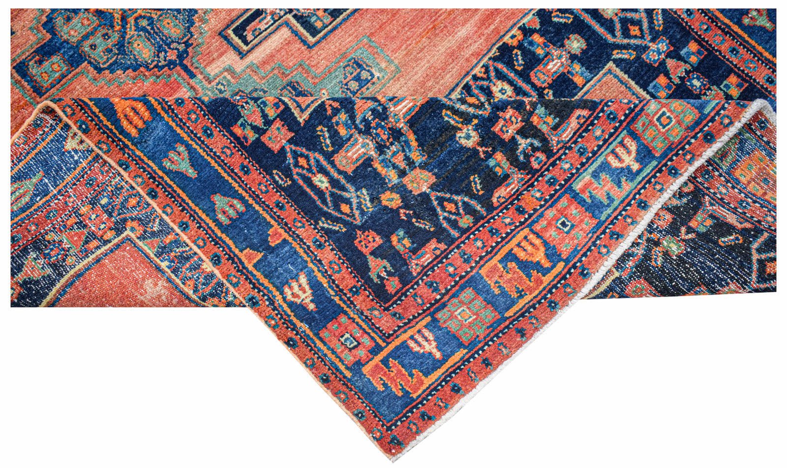 Vintage Persian rug with intricate geometric patterns in blue, orange, and red.