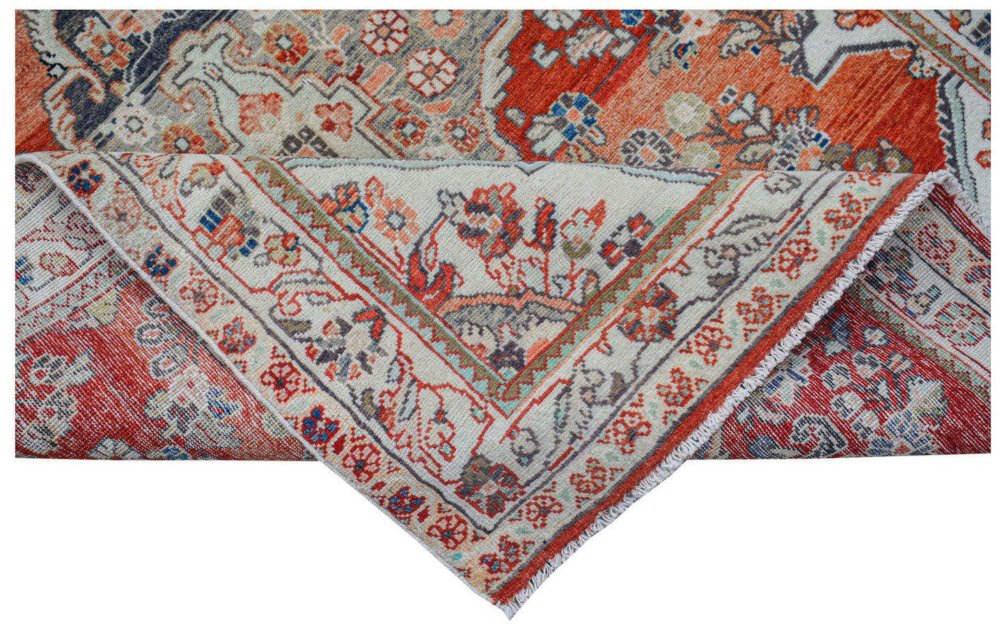 A handwoven vintage Persian rug featuring intricate floral patterns in red, blue, and cream tones.