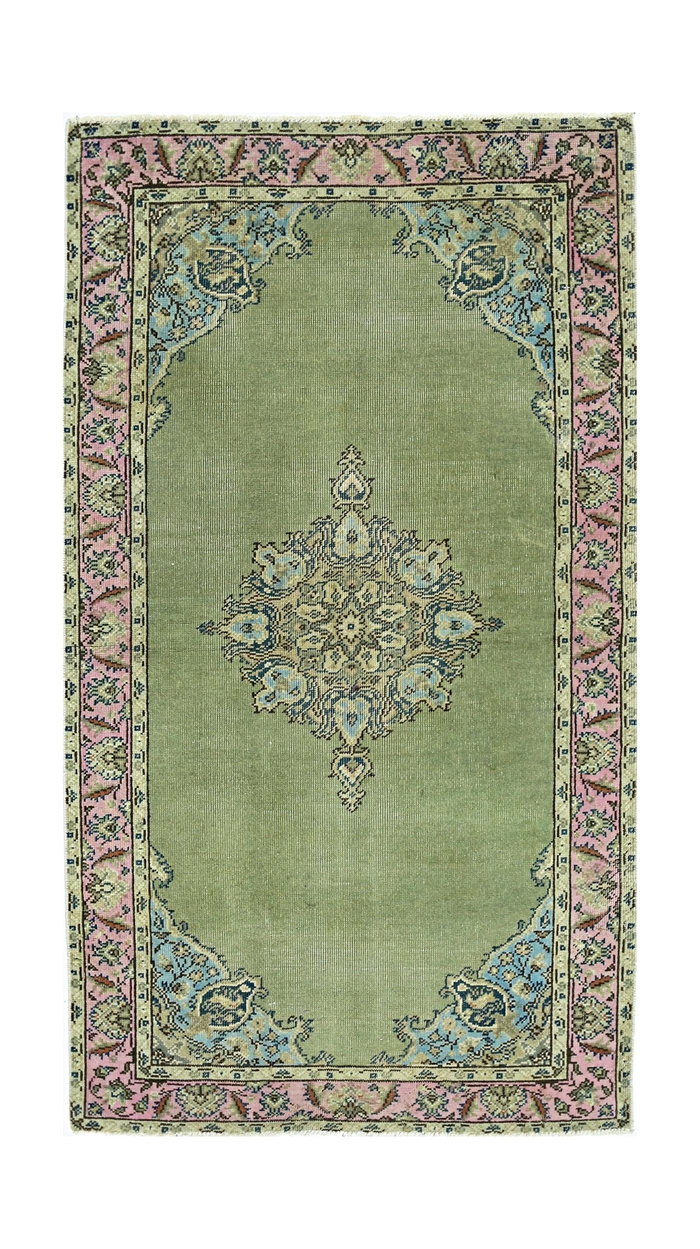 A vintage handmade Persian rug featuring a central floral medallion on a sage green field.