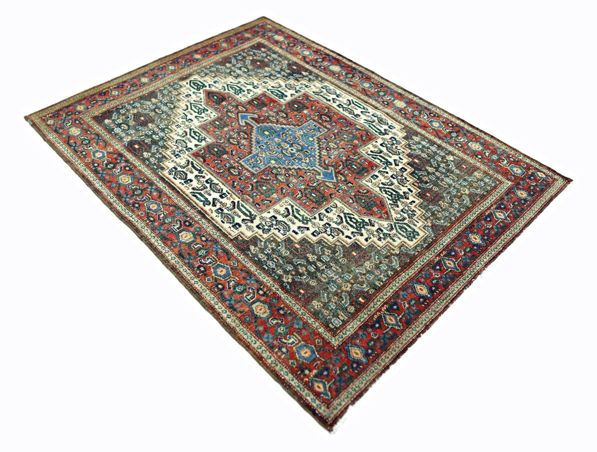 A vintage Persian Senneh rug featuring a central blue medallion on a red and cream patterned field.