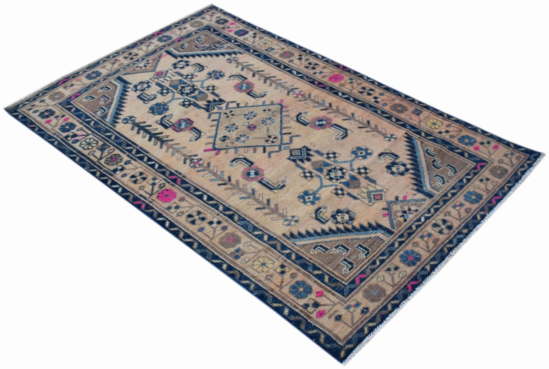 A handwoven vintage Persian rug featuring a geometric floral pattern in blue and beige tones.